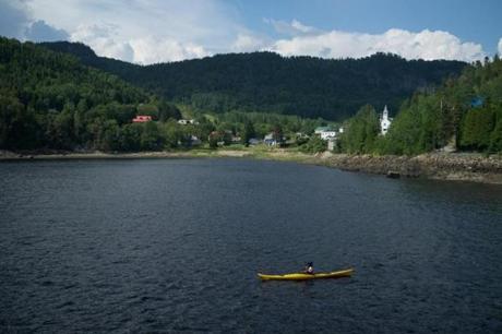 The waters near the Saguenay Fjord offer kayakers amazing views of the Quebec countryside.
